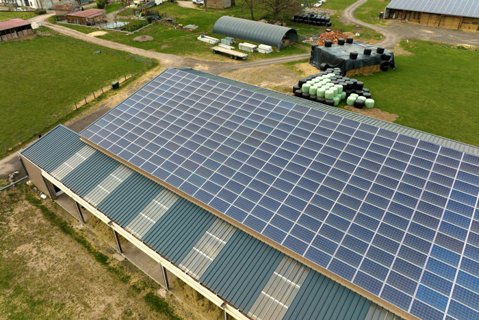 Solar panel icon with a sun in the background, representing renewable energy solutions.